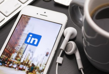 LinkedIn icon on a mobile device on a coffee table